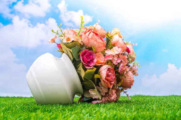 Beautiful of artificial flowers on grass — Stock Photo, Image