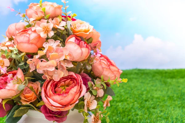 Beautiful of artificial flowers on grass — Stock Photo, Image