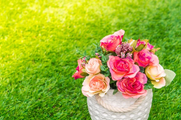 Beautiful of artificial flowers on grass — Stock Photo, Image