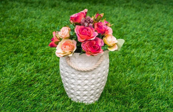 Beautiful of artificial flowers on grass — Stock Photo, Image