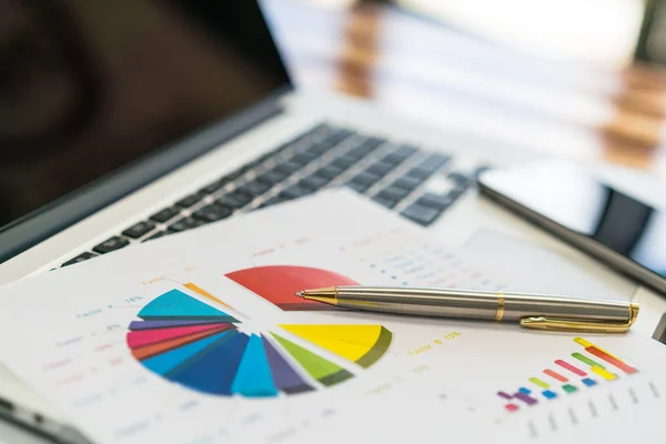 Financial charts on the table with laptop . — Stock Photo, Image