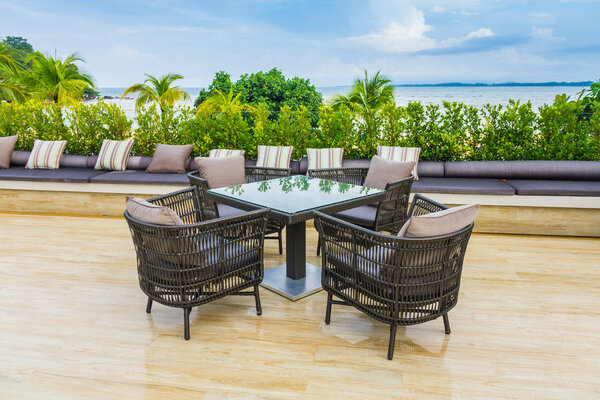Table and chairs at restaurant in tropical sea