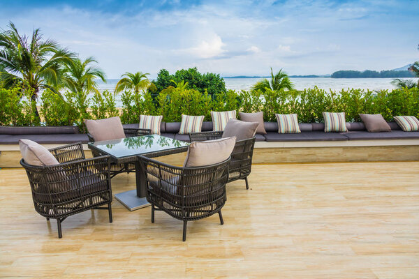 Table and chairs at restaurant in tropical sea