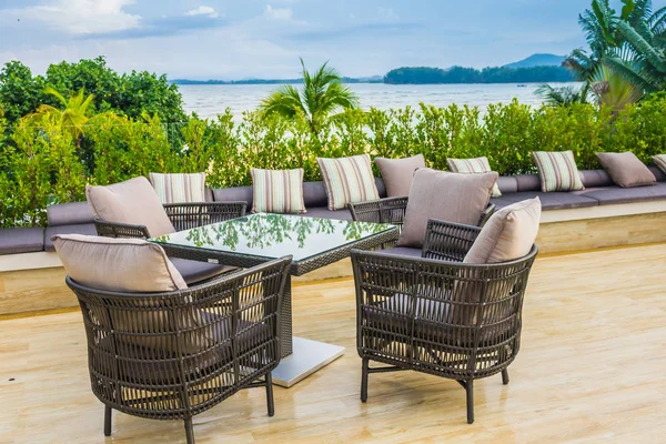 Table and chairs at restaurant in tropical sea