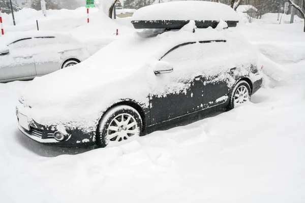 Cars covered with white snow in winter