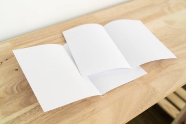 A4 yarım katlı boş beyaz şablon modeli ve ahşap yüzey üzerine sunum tasarımı. 