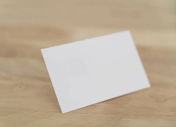 Blank business cards mock up on wooden surface.