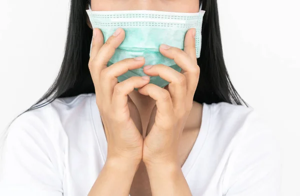 A woman wears a face mask that protects against the spread of Coronavirus (COVID-19). Surgical mask. Medical mask. Face mask.