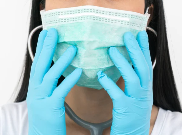 A woman wears a face mask that protects against the spread of Coronavirus (COVID-19). Surgical mask. Medical mask. Face mask.