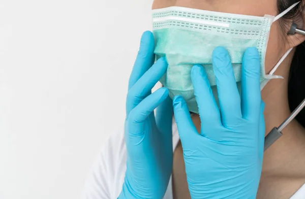 A woman wears a face mask that protects against the spread of Coronavirus (COVID-19). Surgical mask. Medical mask. Face mask.