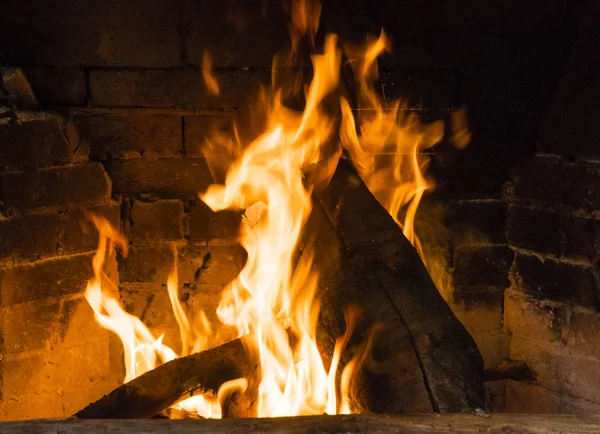 burning pieces of wood in fireplace