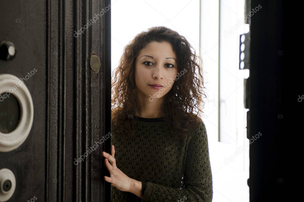  Woman in green sweater standing in doorway