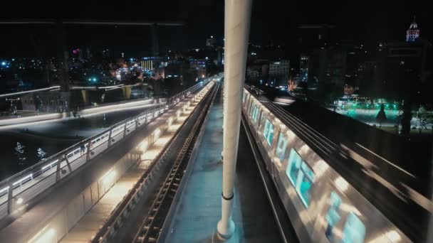 Metro Train Pulls Platform Bridge Overlooking Night City Public Transportation — Stock Video