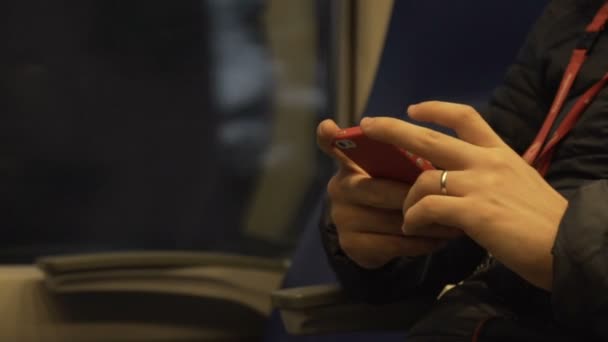 The man on the train is involved in his smartphone. Slow motion — Stock Video