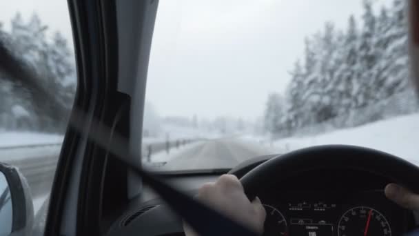 Man driving a car through the winter road — Stock Video