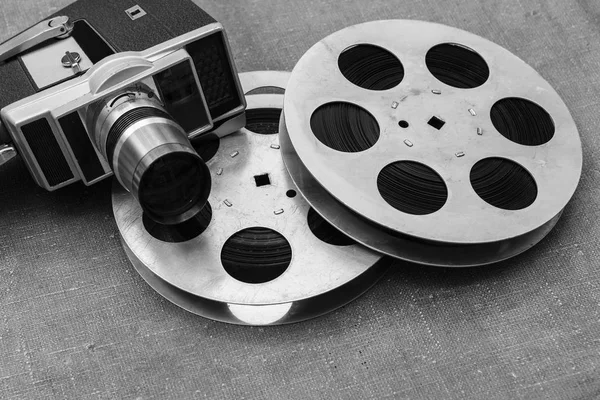 Old movie camera, film reels and clapperboards - Stock Image