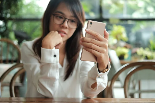 Asia mujer usando el teléfono móvil con cámara frontal para selfie y s — Foto de Stock