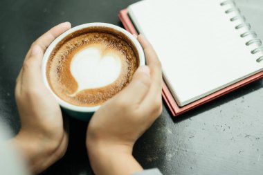 Üstten Görünüm. kadın her iki tarafında bir fincan bir dokunmatik el kullanın 