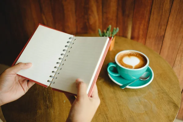 Top view. hand of business woman hold blank notebook has cup wit — Stock Photo, Image