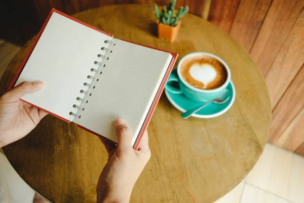 Top view. hand of business woman hold blank notebook has cup wit — Stock Photo, Image