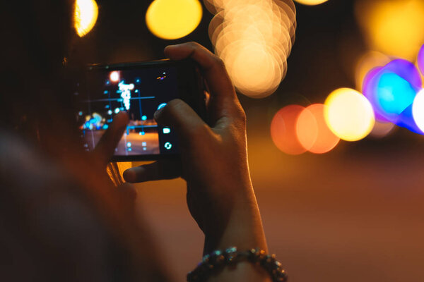 technology background hand hold mobile phone for photography wit