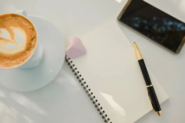 Business equipment with pen, blank notebook, cup with coffee, mo — Stock Photo, Image