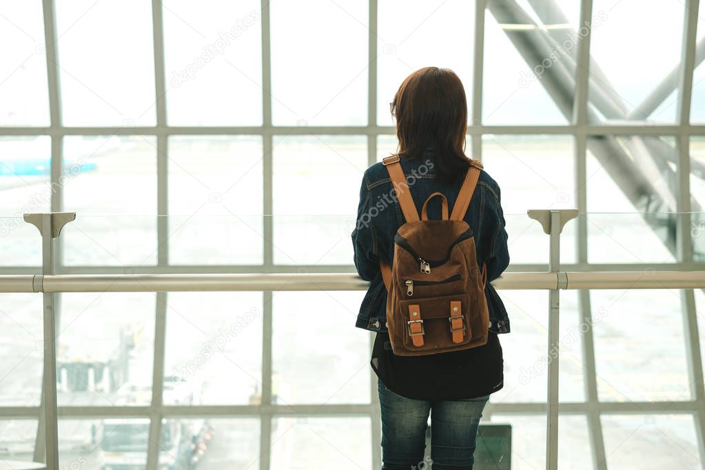 travel background caucasian woman with backpack stand alone in a