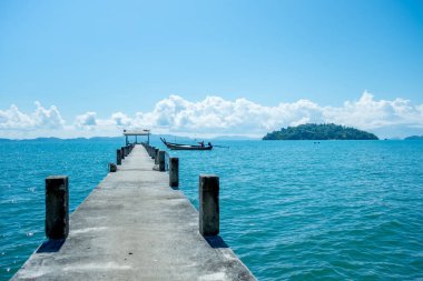 Manzara konsepti. Orta denizdeki beton köprü. Tekne ve gökyüzü arka planı.