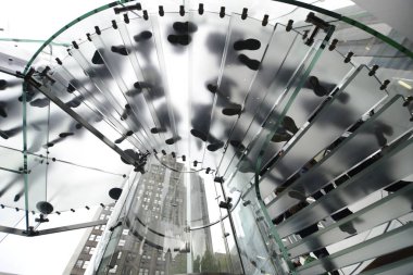 Siluet insanlar üzerinde yürüyen merdiven görüyorum. Kentsel Yaşam, modern Cam mimari, iş ve yaşam tarzı kavramı. 