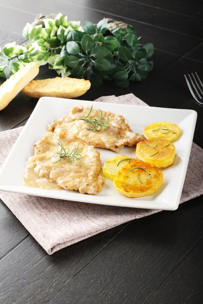 Scaloppina with rosemary and baked potatoes — Stockfoto