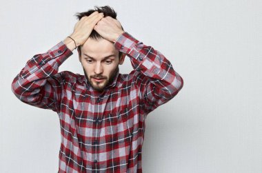 Young Caucasian man with beard in  despair covers his head with hands. Worry due to problems and stress. Missed opportunities due to poor memory. Human emotion concept clipart