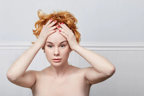 Human face expressions and emotions. Portrait of nude young Caucasian desperate redhead woman in panic, holding her head with both hands. Female in despair , forgot very important thing. — Stock Photo, Image