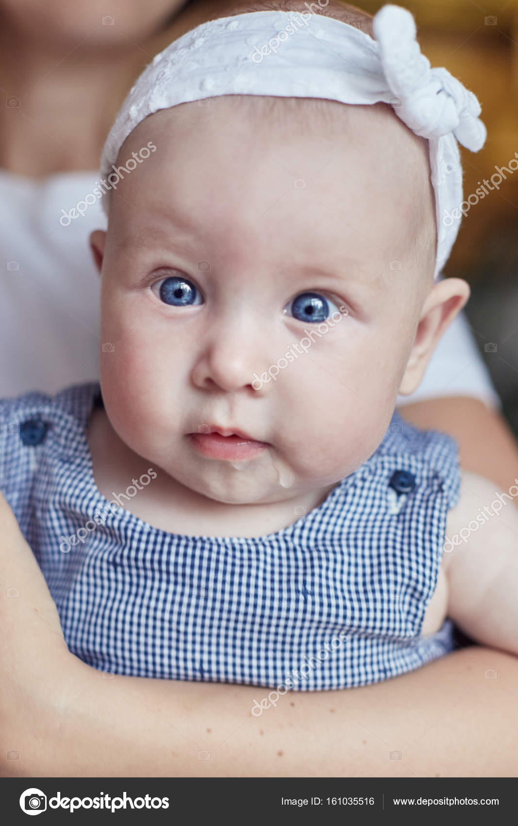 Portrait Of Cute Caucasian Infant With Blonde Hair And Big