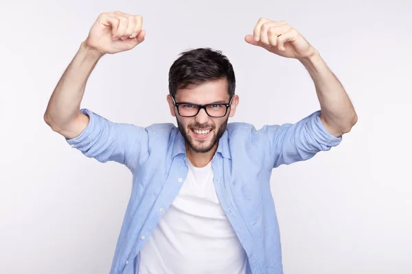 ¿Sí? Indoor shot of handsome excited lucky young European or American student exclamando en emoción, animando y gritando de alegría, manteniendo las manos apretadas después de pasar todos los exámenes en la universidad . — Foto de Stock