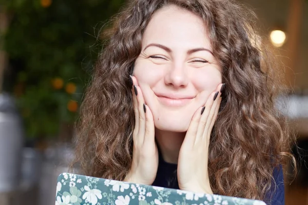 Positive body language emotions. Close-up of childish Caucasian female student with funky hair blowing cheeks bursting out laughing having joy looking happily into camera. Beautiful lady touches face. — Stock Photo, Image