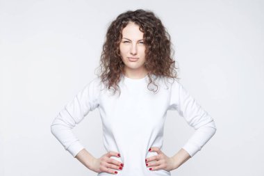 Skandal, olacak beyaz esmer kadın siyah kıvırcık saçlı görünümü kuşkuyla içine kamera, ihanet, şüpheliler kocası ile kıskanç, beyaz arka plan üzerinde izole. Güzellik ve gençlik.