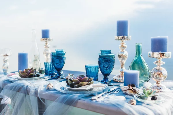 table decorated with blue tableware and decor