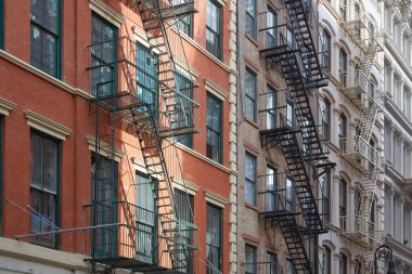 New York building facades with fire escape stairs, sun beam clipart