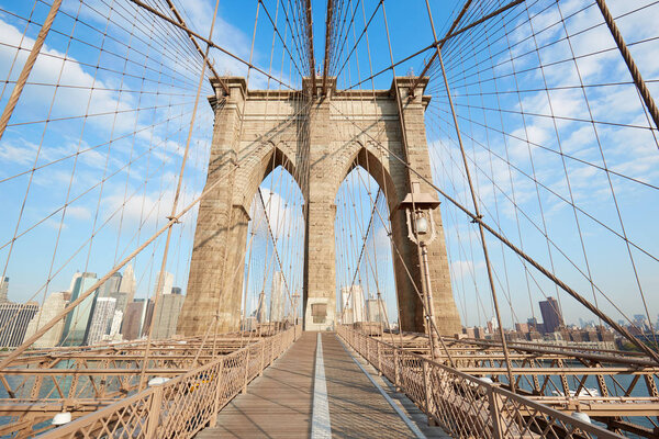 Empty Brooklyn Bridge view in a sunny day, central perspective in New York