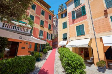 Portofino Italian village with colorful houses facades and luxury shops clipart