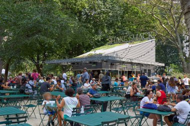 Shack Restoran Madison Square Park'ta otururken, insanlarla açık tablolar sallamak.