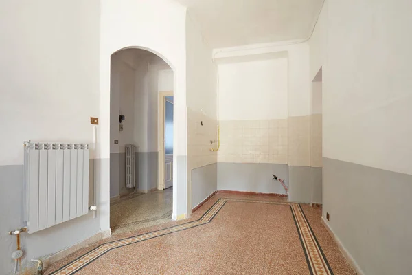 Empty living room and kitchern area interior in old apartment with tiled floor