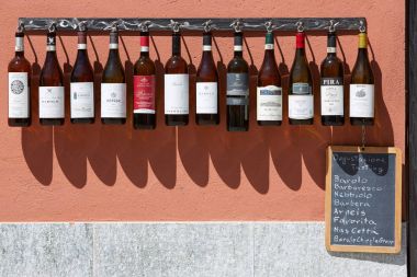 Piedmont wine bottles collection in front of winery in a sunny day in Italy clipart