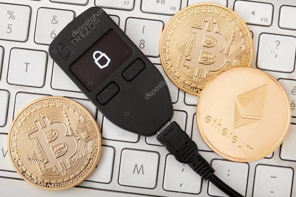 Trezor hardware wallet for cryptocurrency on keyboard with g