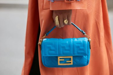 Emporio Armani moda defilesinden önce mavi deri çantalı ve turuncu ceketli kadın, Milan Moda Haftası 