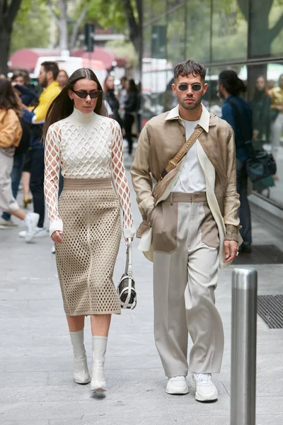 Emporio Armani moda defilesinden önce, bej renkli kıyafetlerle yürüyen kadın ve erkek, Milan Moda Haftası tarzı. — Stok fotoğraf