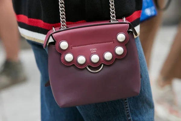 Woman with burgundy Fendi ather bag before Emporio Armani fashion show, Milan Fashion Week street style — стокове фото