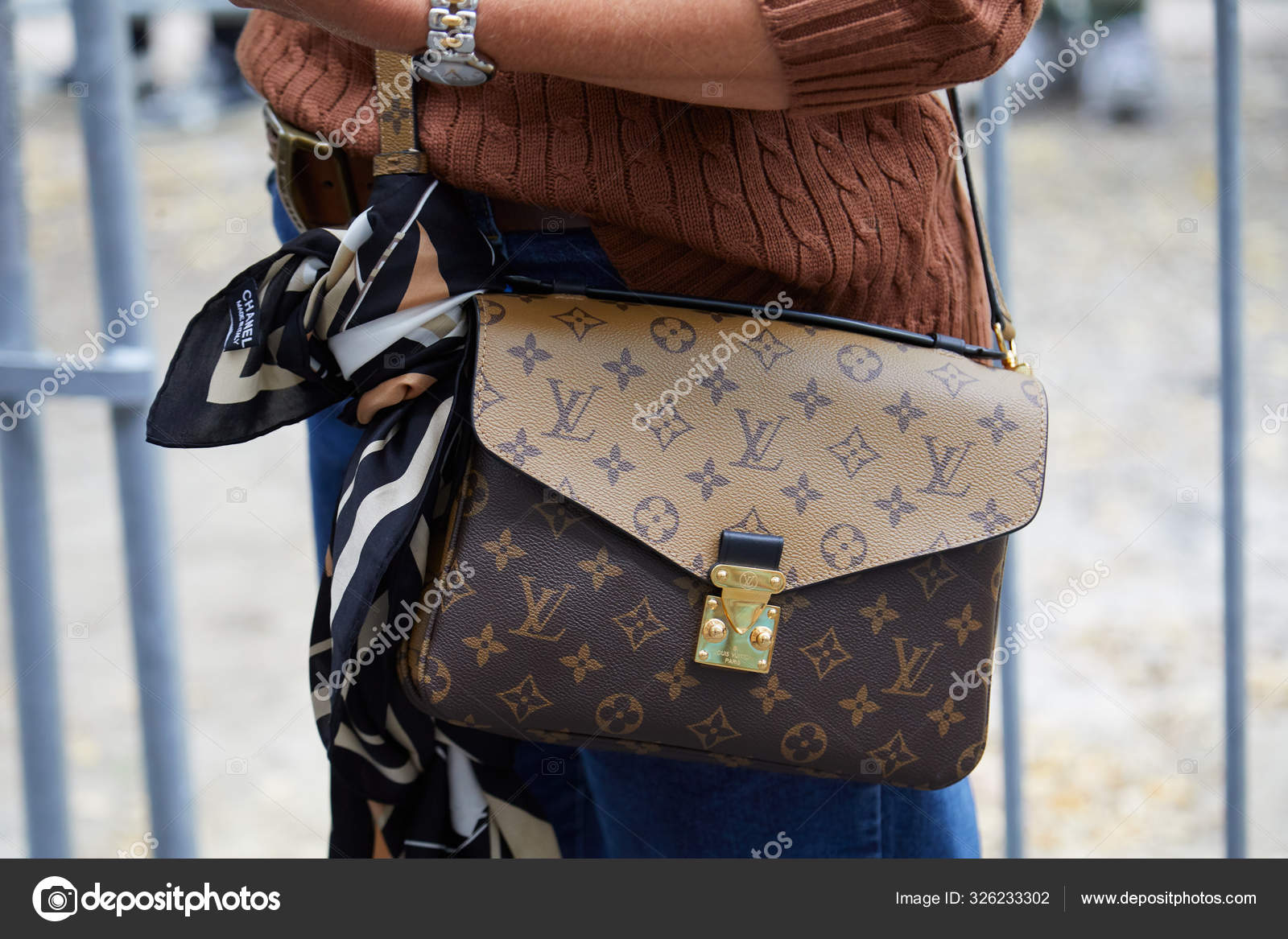 Woman with Louis Vuitton bag and Chanel scarf before Fendi fashion