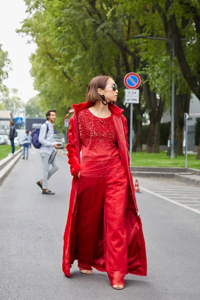 Donna con pelliccia rossa e occhiali da sole prima della sfilata di Emporio Armani, Milano Fashion Week street style — Foto Stock