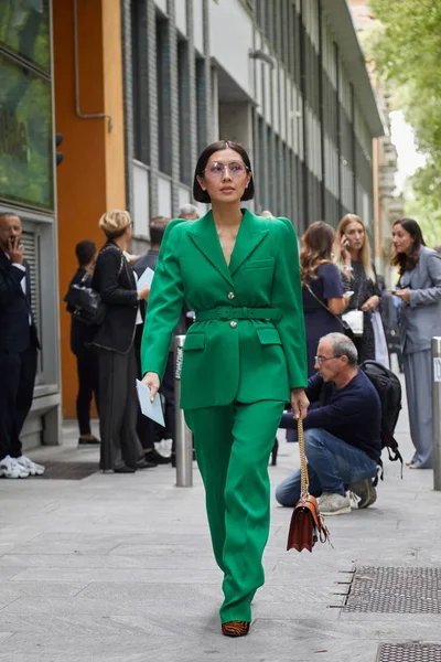Woman with green Givenchy jacket and trousers before Emporio Armani fashion show, Milan Fashion Week street style — Stock Photo, Image
